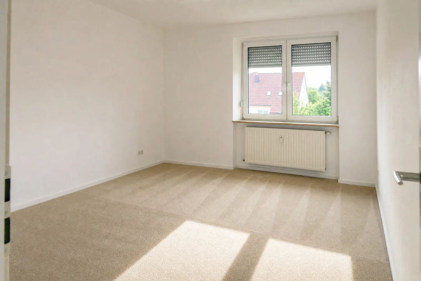 Empty bedroom with freshly cleaned wall-to-wall carpet showing even cleaning lines